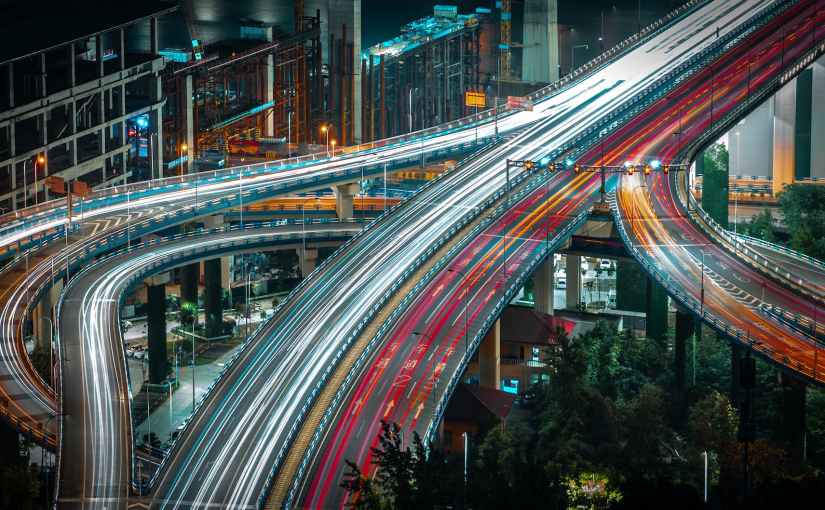 cars driving on urban highway in evening