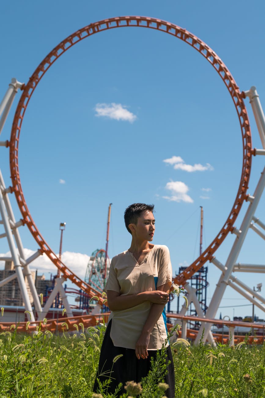 short haired woman standing on flowering plants