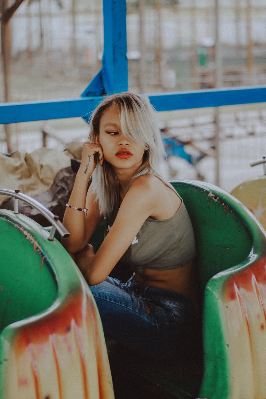 woman sitting on green and red roller coaster