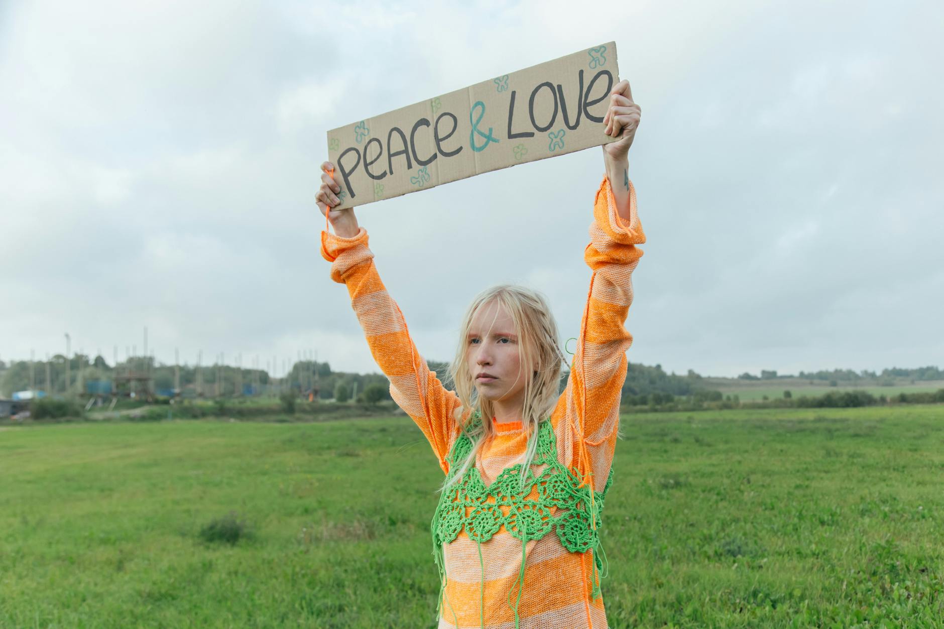 a woman raising her hands while holding a banner