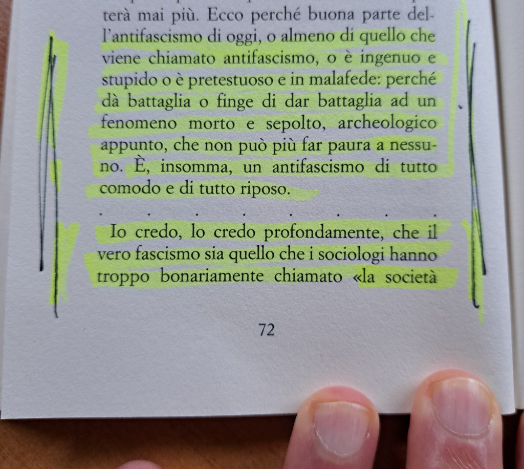 A close-up image of a page from a book, featuring highlighted text and a person's fingers holding the page.